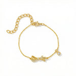 18k Gold plated  bracelet with a bow design on a white background