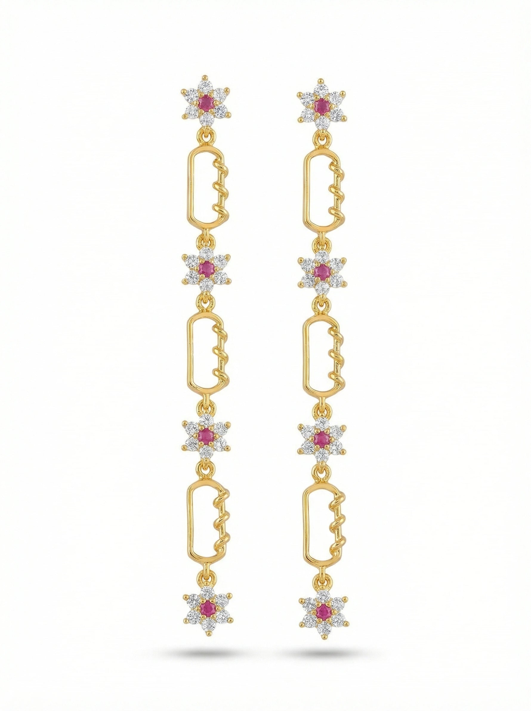 18k Gold plated earrings with star-shaped elements and red gemstones on a white background