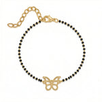 Bracelet with black beads and 18k gold plated butterfly charm on a white background