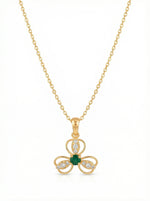 18k Gold plated necklace with a clover-shaped pendant featuring a green gemstone on a white background