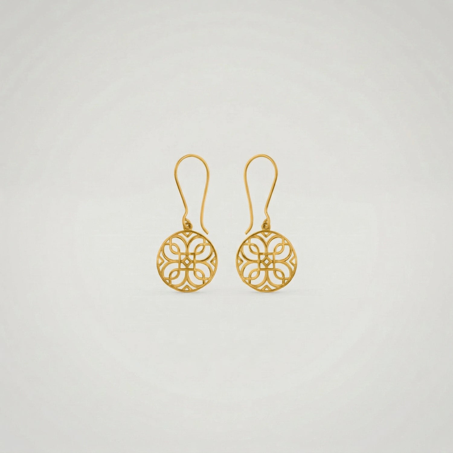 Pair of 18k gold plated earrings on a light gray background