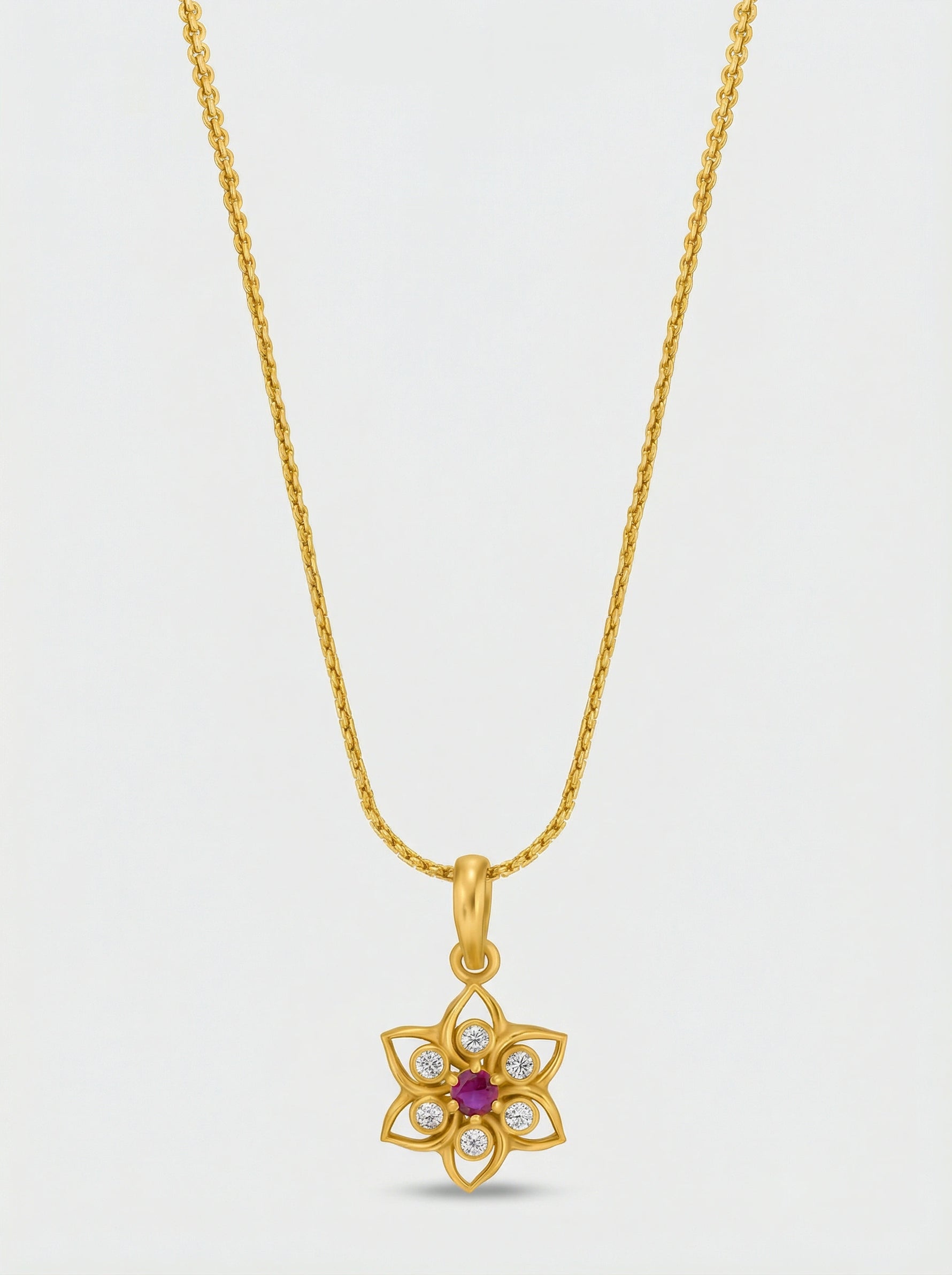 18k Gold plated necklace with a floral pendant on a light gray background
