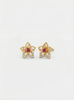 18k Gold plated flower-shaped earrings with red gemstones on a white background