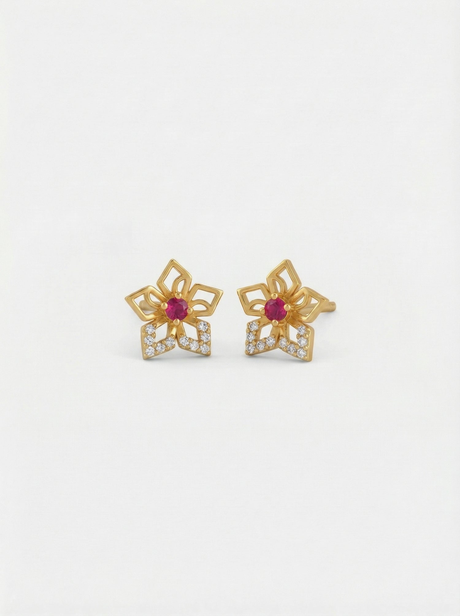 18k Gold plated flower-shaped earrings with red gemstones on a white background
