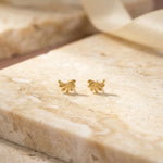 18k Gold plated butterfly-shaped earrings on a marble surface