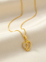 18k Gold plated necklace with a heart-shaped pendant on a beige background