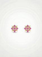 Pair of 18k gold plated earrings with pink gemstones on a white  background