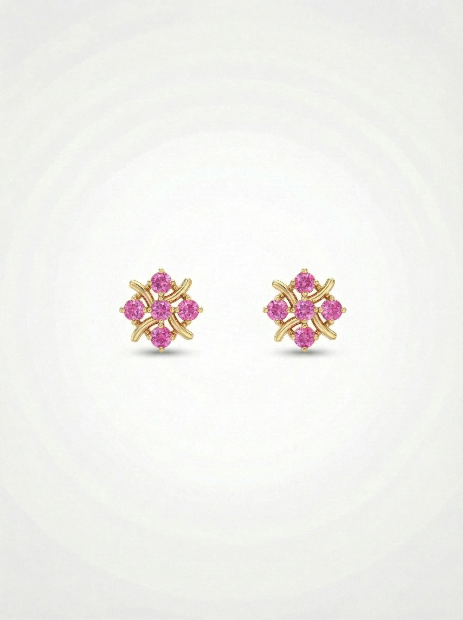 Pair of 18k gold plated earrings with pink gemstones on a white  background