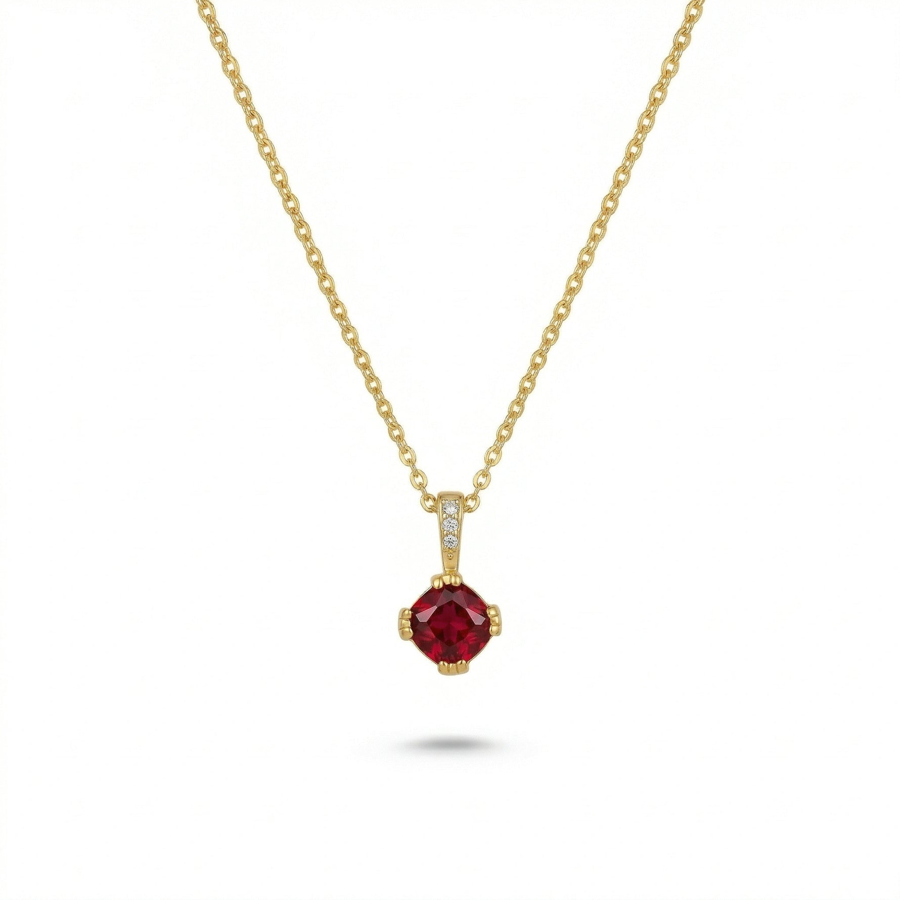 18k Gold plated necklace with a red gemstone pendant on a white background