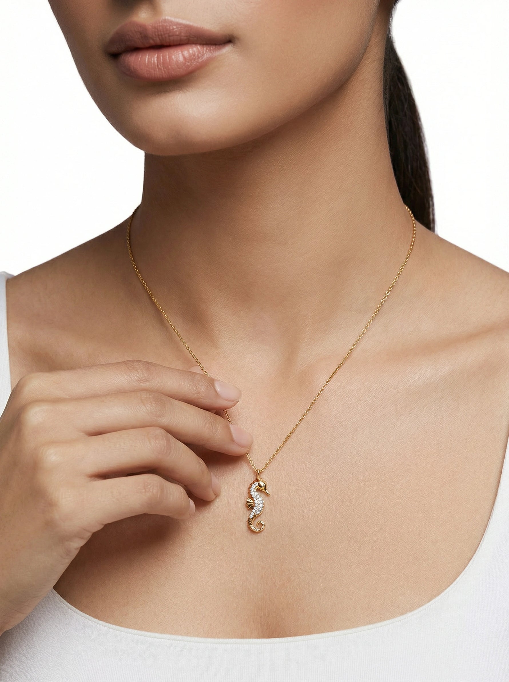 18k Gold plated necklace with a seahorse pendant worn by a person