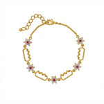 18k Gold platedbracelet with star-shaped links and red gemstones on a white background