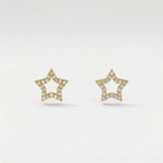 Star-shaped 18k gold plated earrings with diamond accents on a light gray background