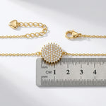 18k Gold plated bracelet with a decorative clasp on a ruler for size reference