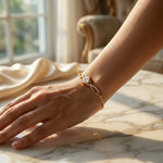 18k Gold plated bracelet with a diamond on a wrist against a blurred indoor background