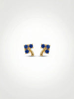 18k Gold plated earrings with blue gemstones on a white background