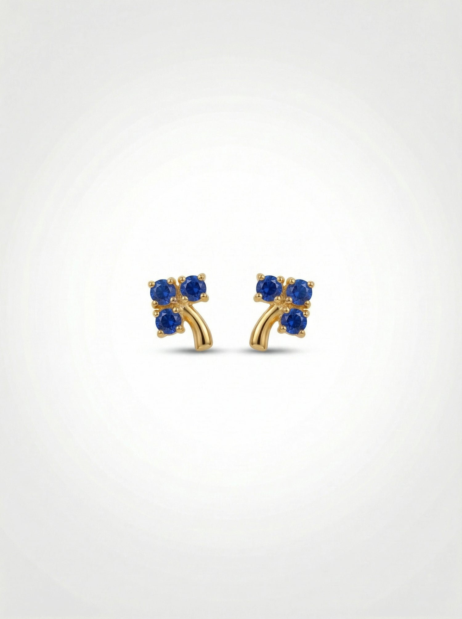 18k Gold plated earrings with blue gemstones on a white background