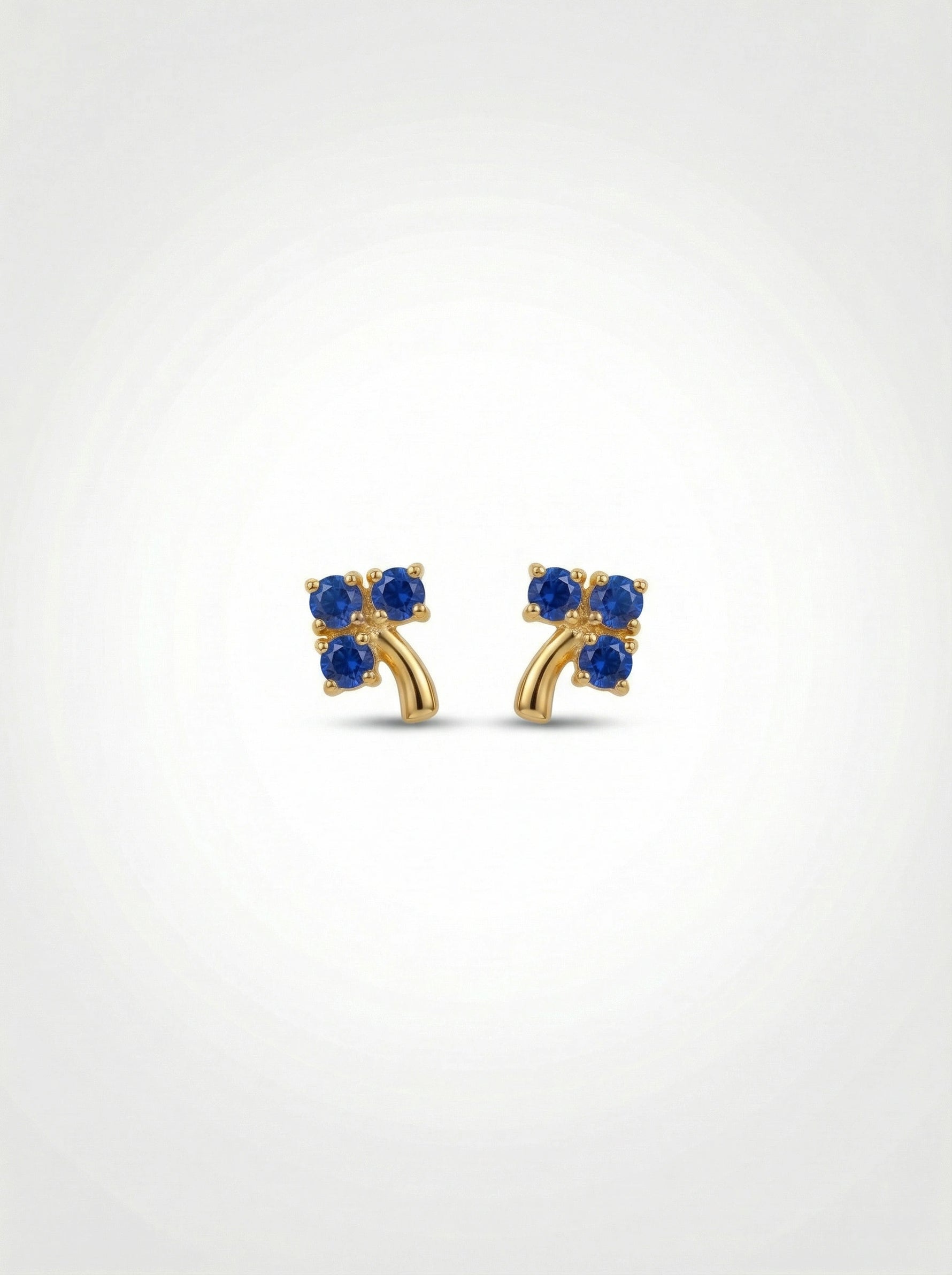 18k Gold plated earrings with blue gemstones on a white background