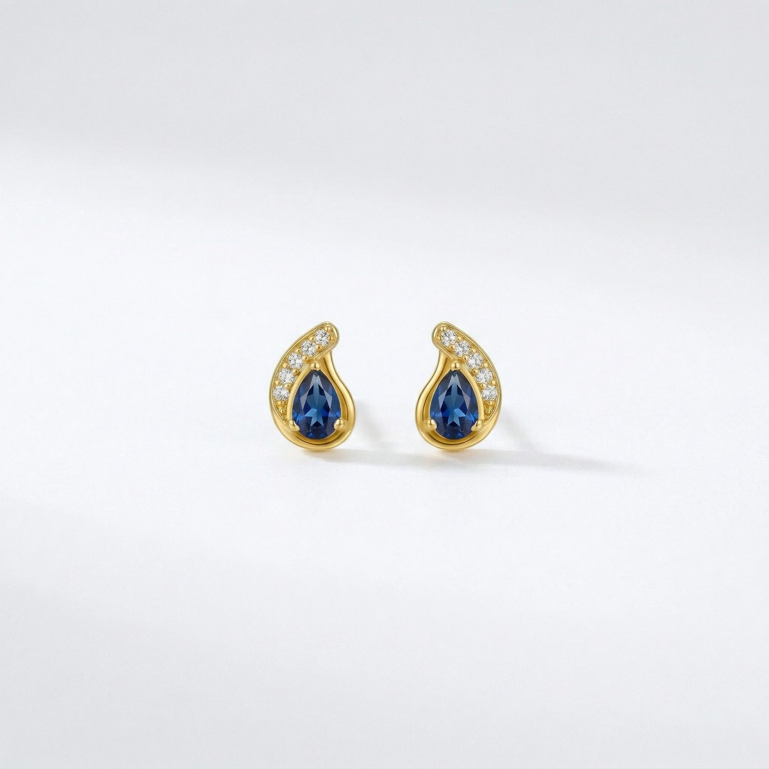 18k Gold plated earrings with blue gemstones on a white background