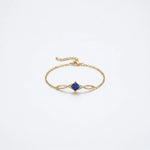 18k Gold plated  bracelet with a blue gemstone on a white background