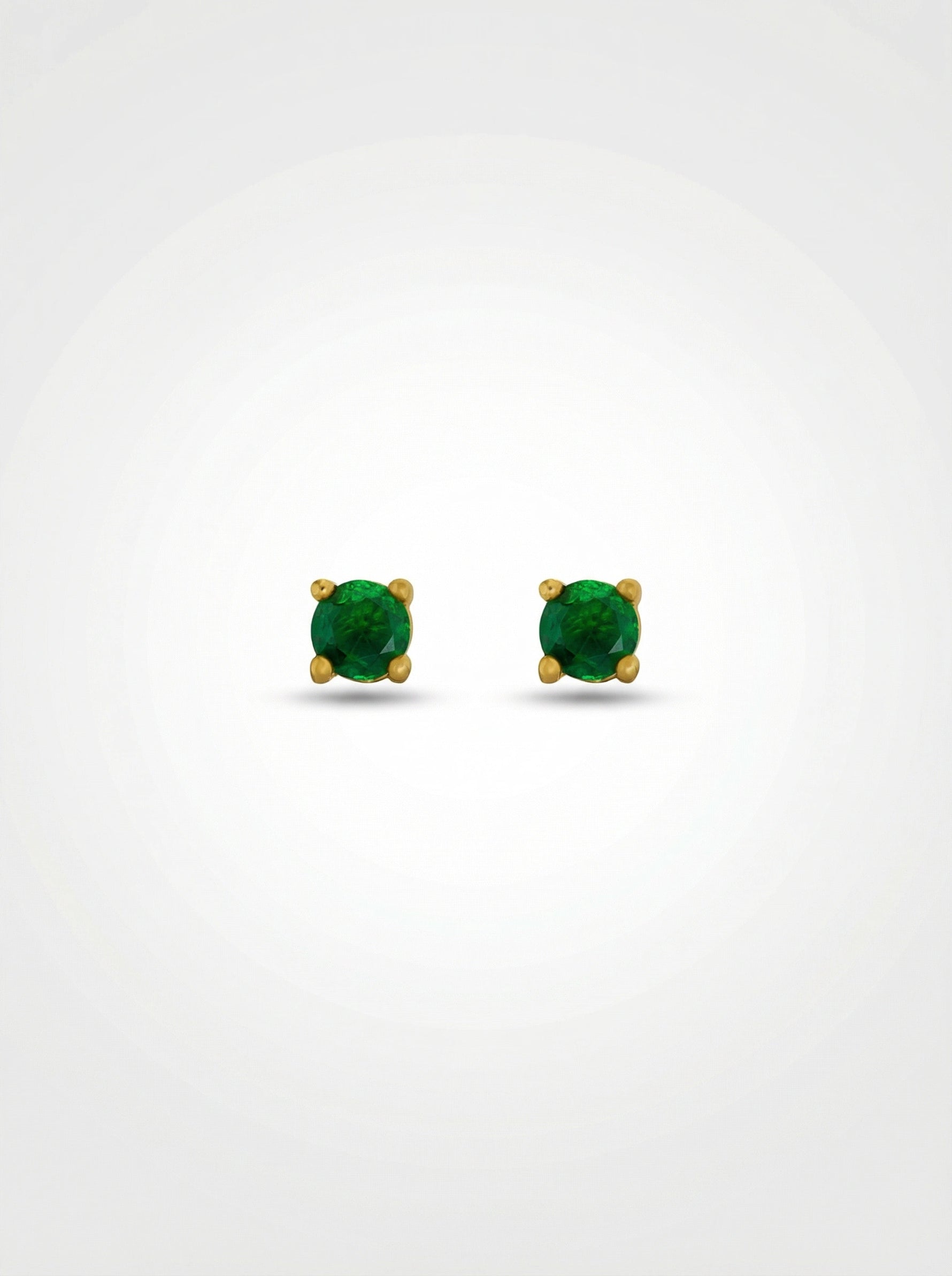 Pair of green gemstone earrings with 18k gold plated settings on a white background