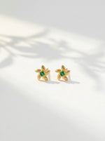 18k Gold plated  earrings with green gemstones on a light background