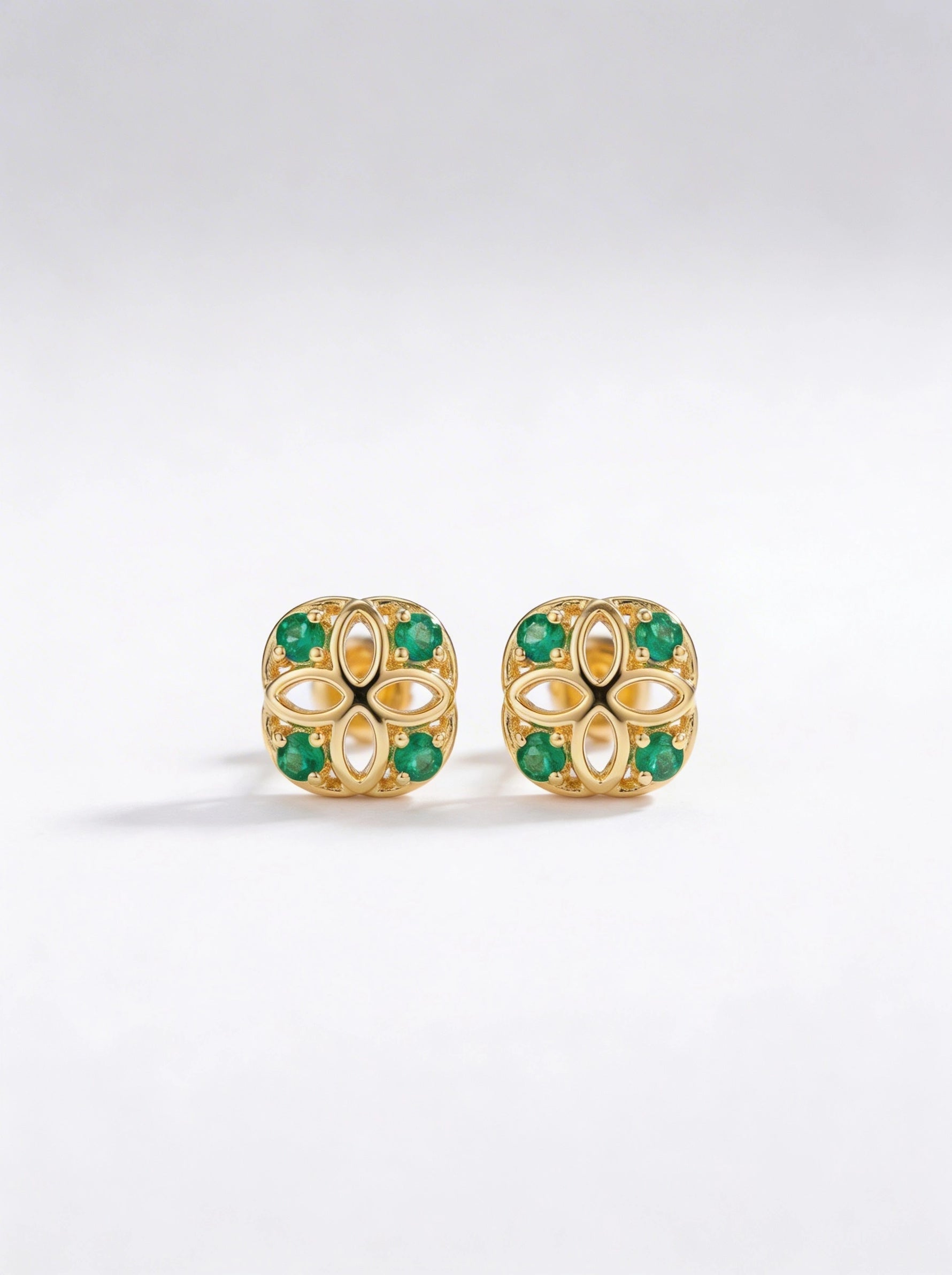 18k Gold plated earrings with green gemstones on a white background