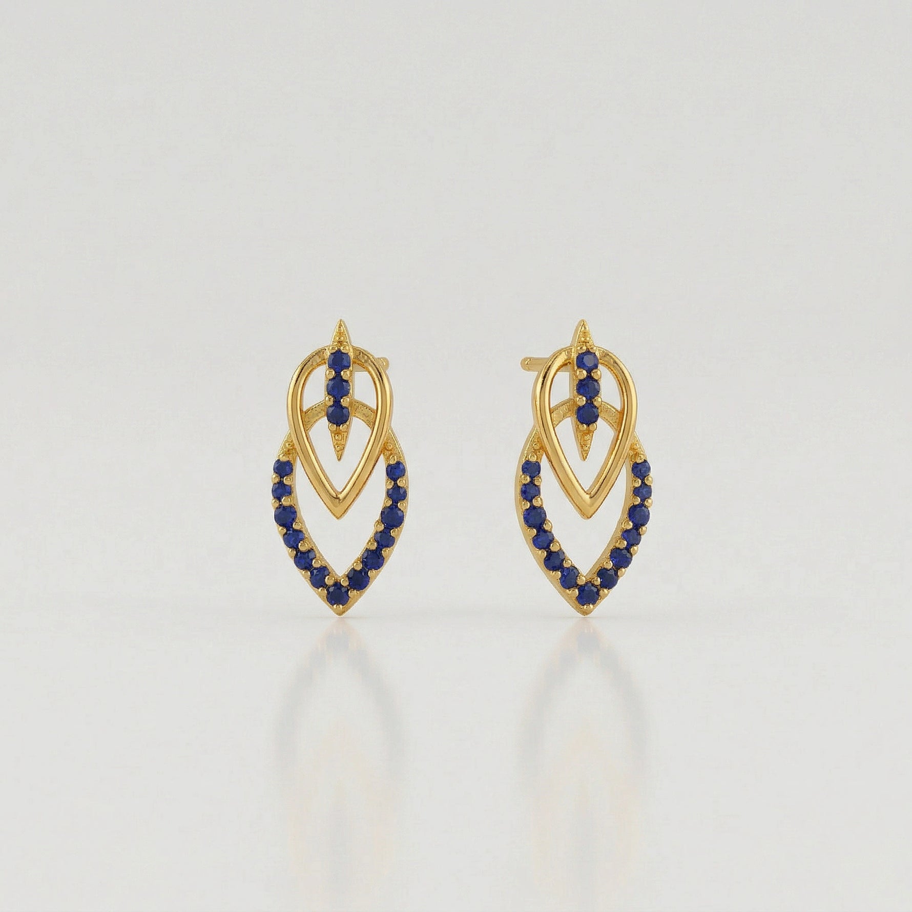 18k Gold plated  earrings with blue stones on a light gray background
