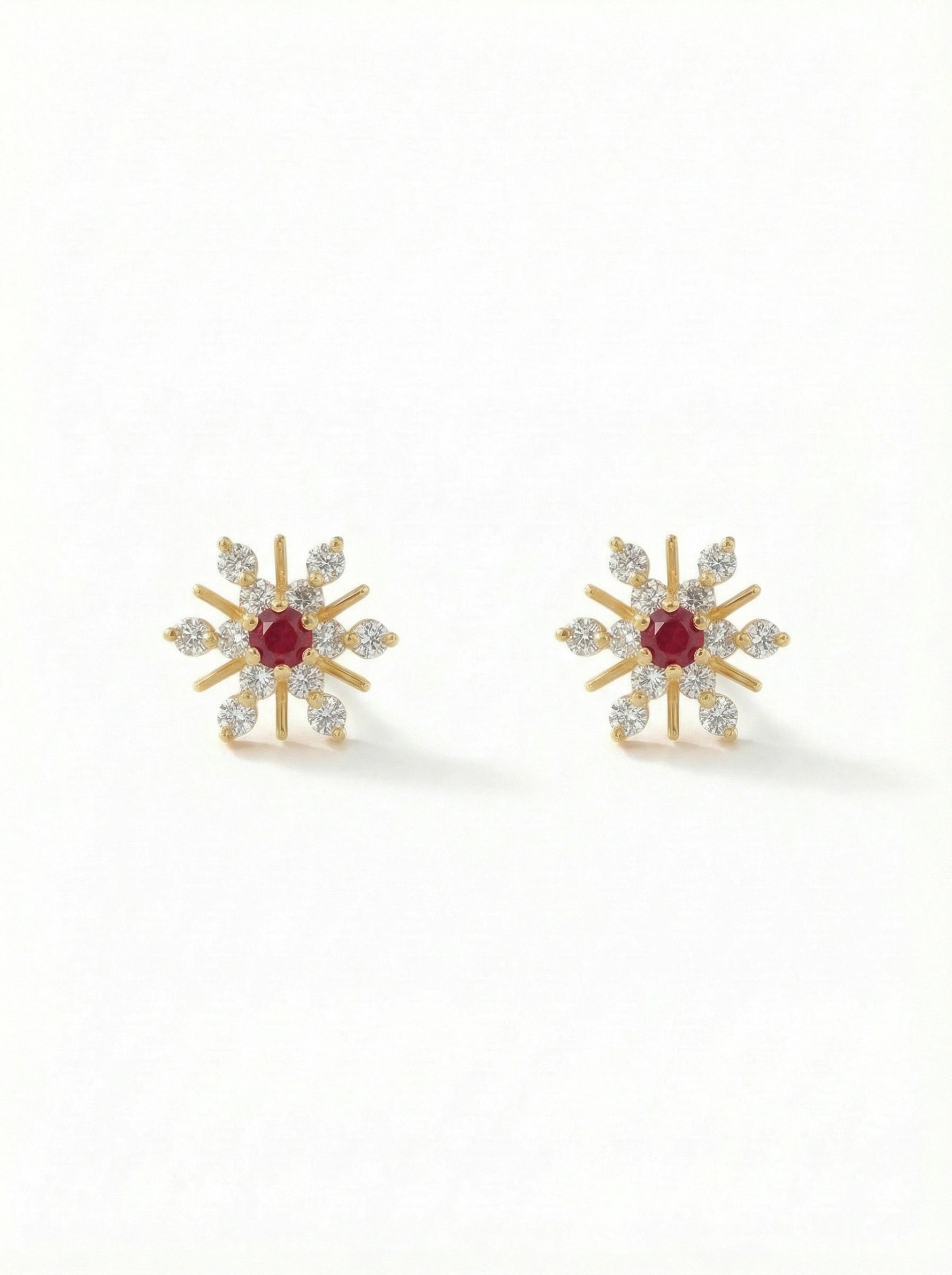 Pair of silver heart-shaped 18k gold plated earrings on a white background