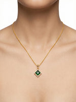 18k Gold plated necklace with a green gemstone pendant on a mannequin