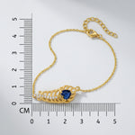 18k Gold plated bracelet with a blue gemstone next to a ruler for measurement on a white background