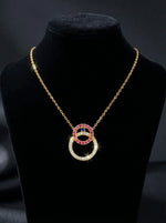 18k gold plated Necklace with interlocking rings on a black stand against a dark background