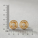 18k Gold plated earrings with diamond accents next to a ruler on a light gray background