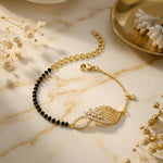 18k Gold plated bracelet with black beads on a marble surface