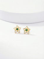 Pair of 18k gold plated earrings with green gemstones on a white background 