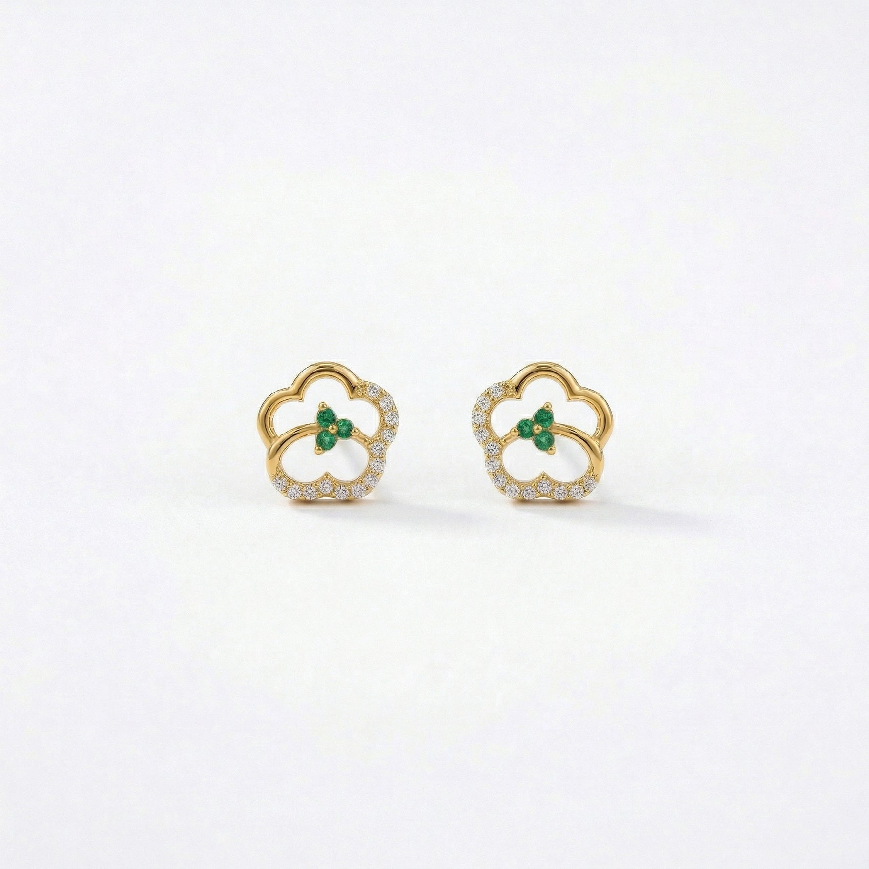 18k Gold plated earrings with green gemstones on a white background