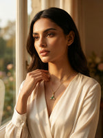 Woman wearing 18k gold plated  necklace with a green pendant indoors