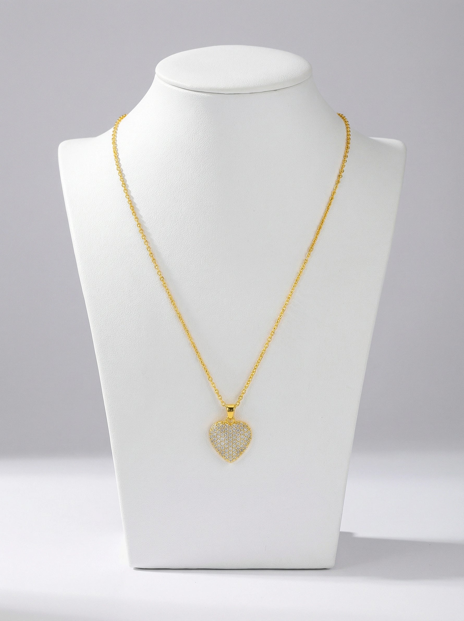 18k Gold plated necklace with a heart-shaped pendant on a white mannequin bust against a gray background