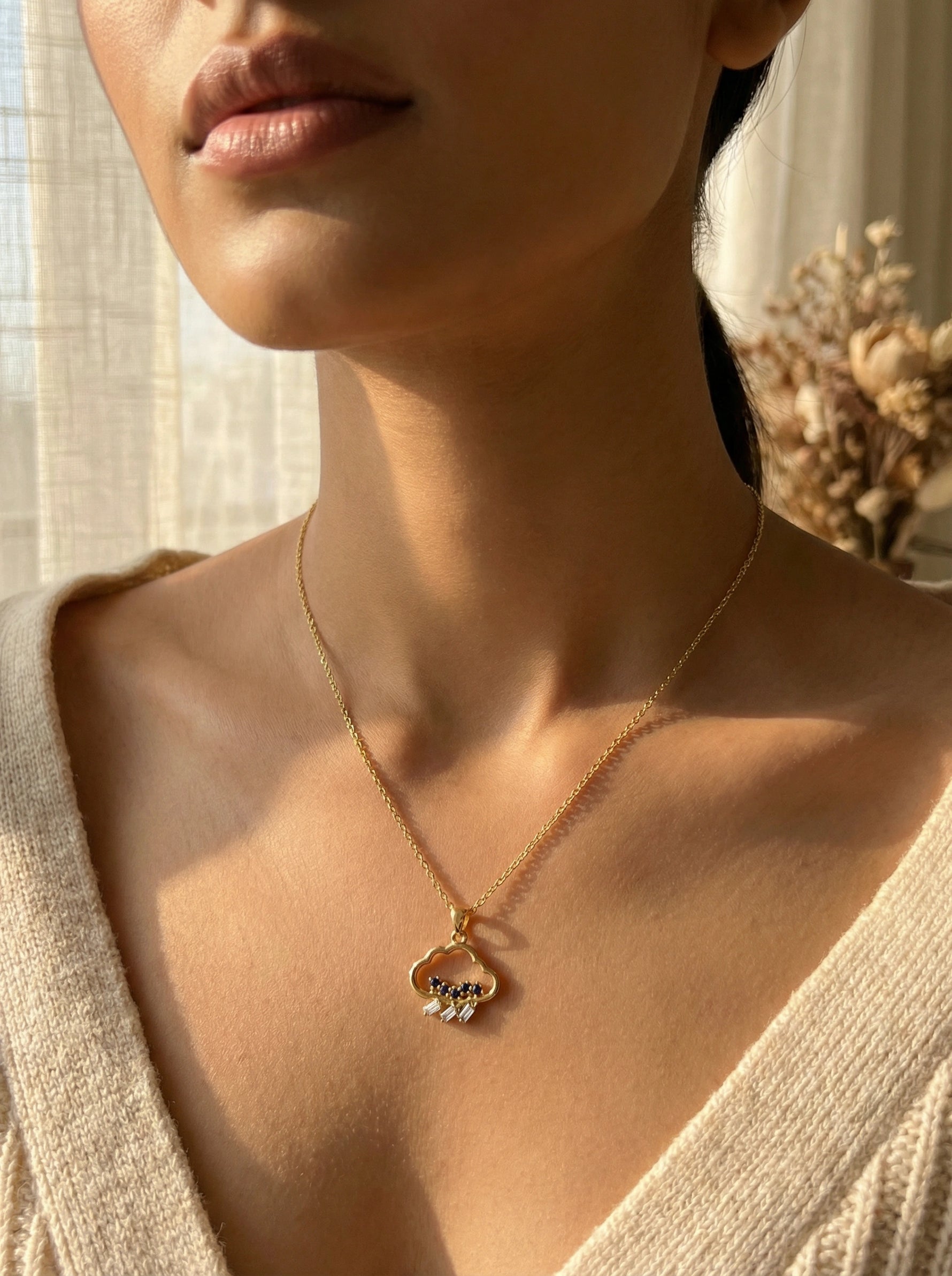 Close-up of a person wearing a 18k gold plated necklace with a heart-shaped pendant.