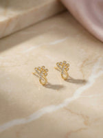 18k Gold plated earrings on a marble surface