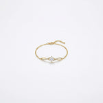 18k Gold plated bracelet with a diamond on a light gray background