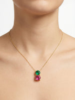 18k Gold plated necklace with green and pink gemstones on a plain background