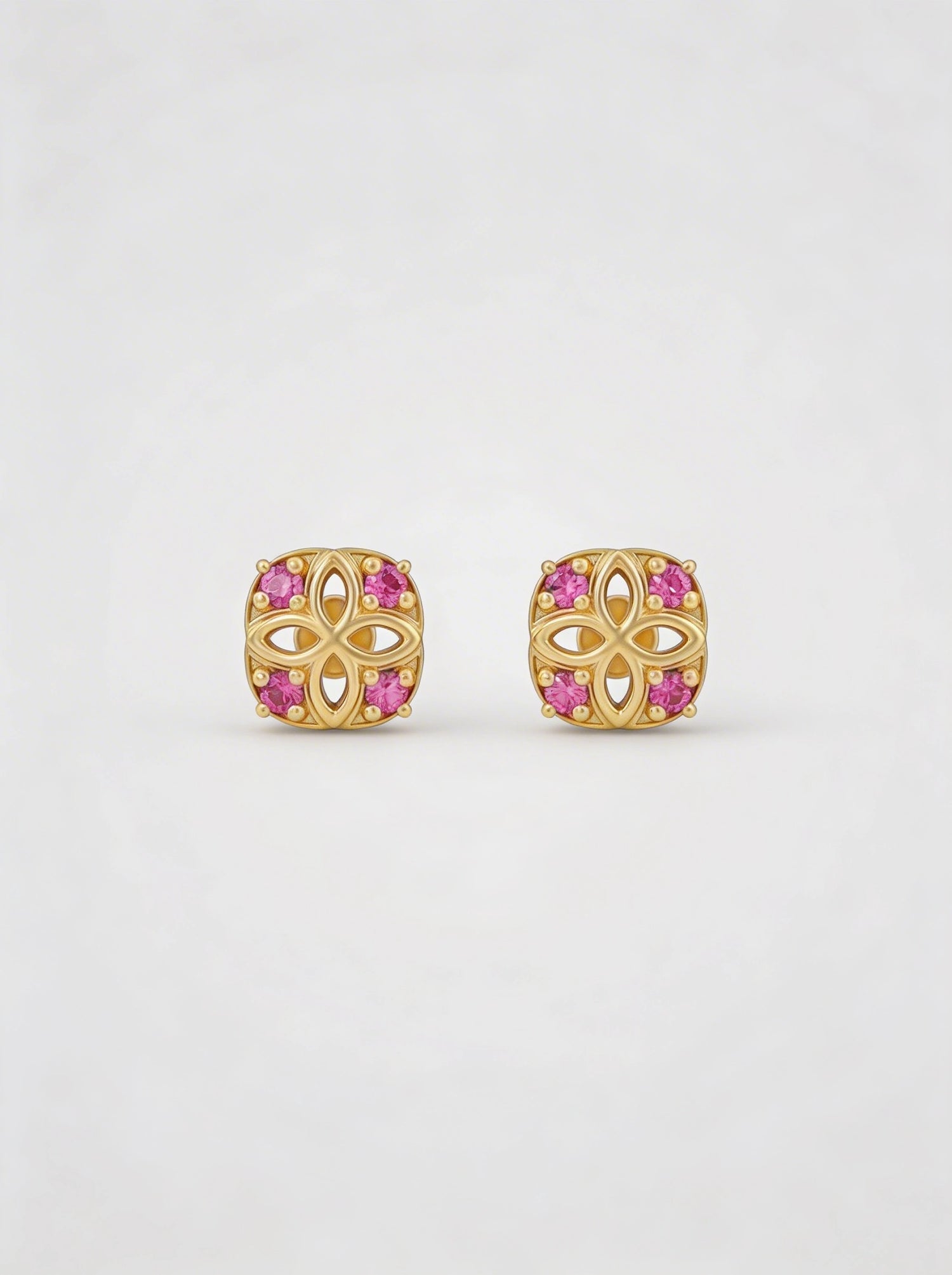 18k Gold plated earrings with pink gemstones on a white background