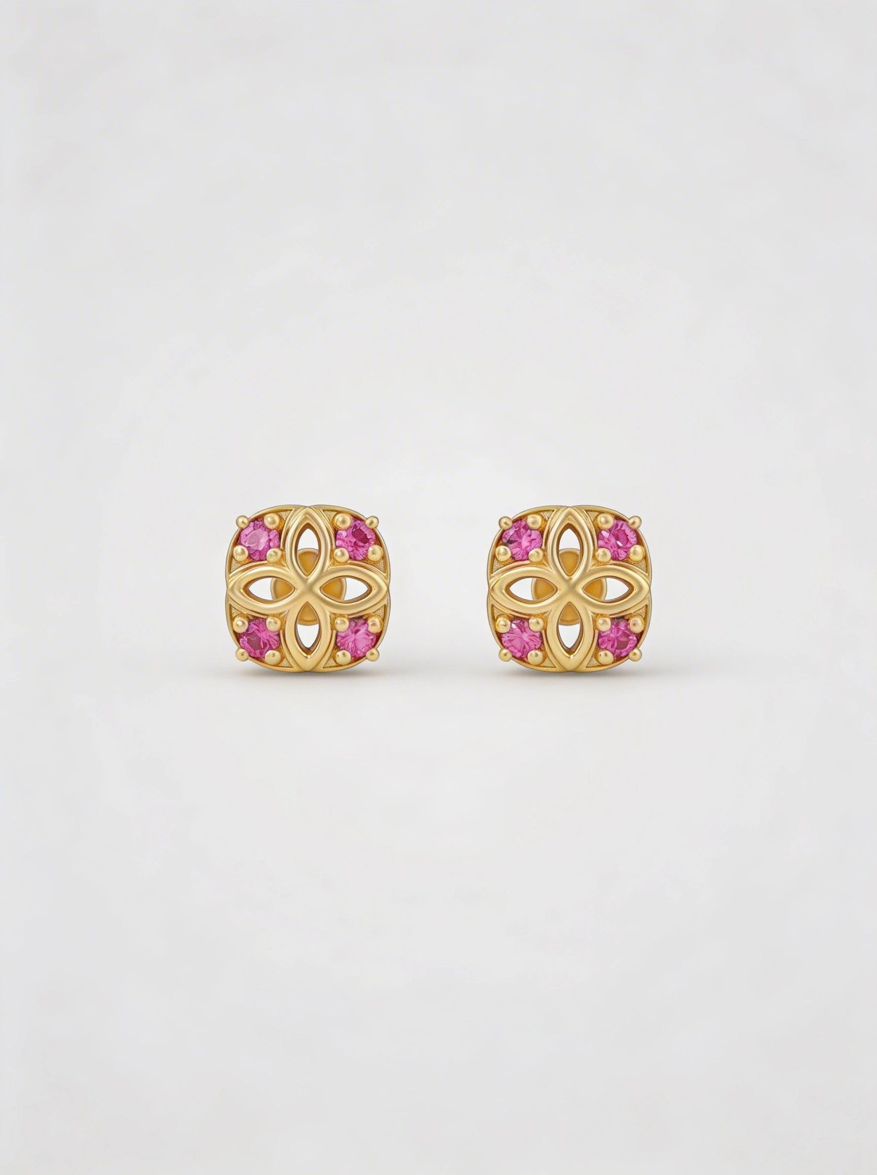 18k Gold plated earrings with pink gemstones on a white background
