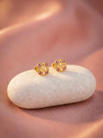 18k Gold plated  earrings with pink gemstones on a white stone against a soft pink background