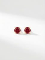 Pair of18k gold plated  red gemstone stud earrings on a white background