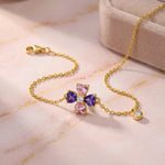 18k Gold plated bracelet with colorful gemstones on a pink marble surface