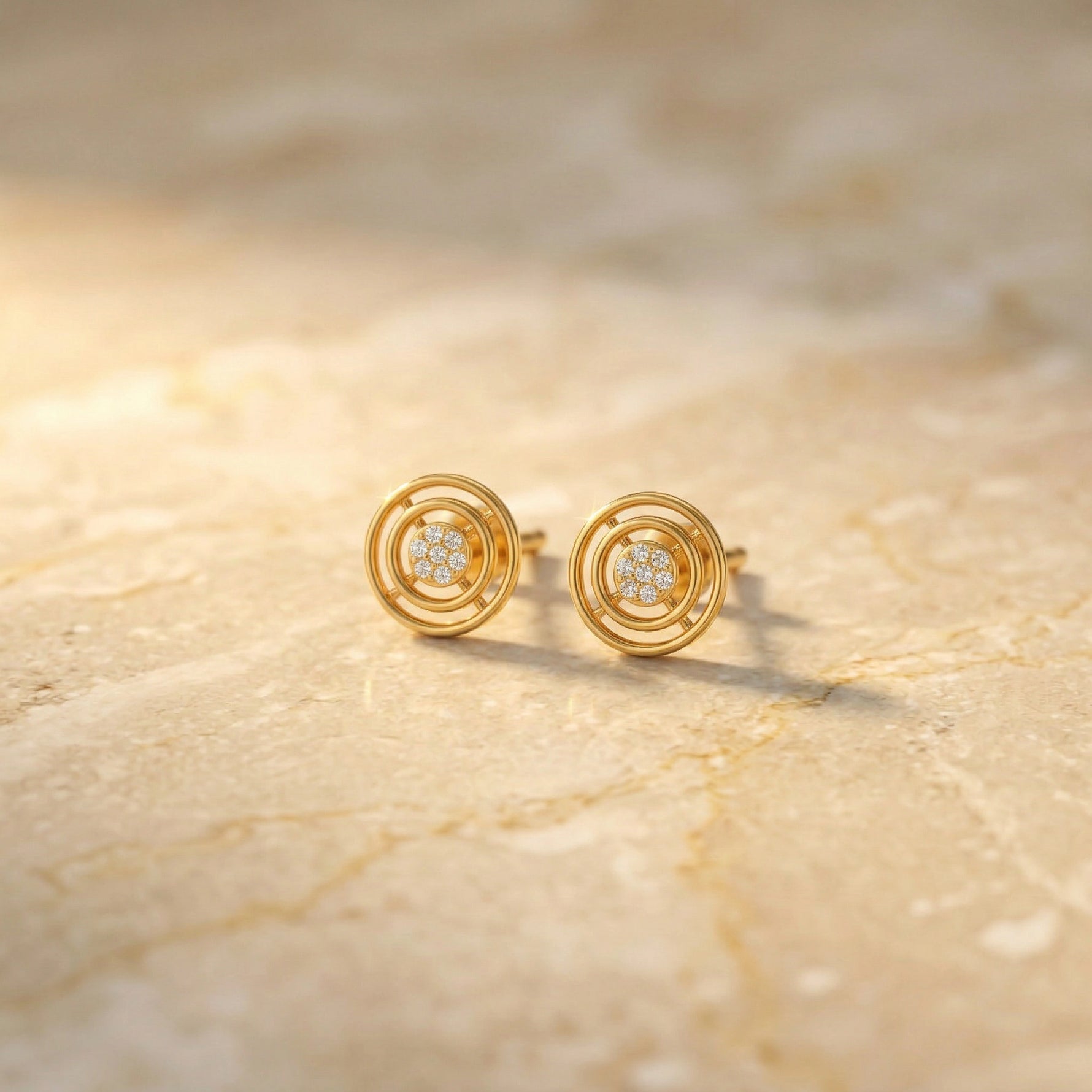 18k Gold plated earrings with diamond accents on a beige marble surface
