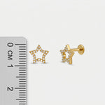 18k Gold plated star-shaped earrings with clear stones next to a ruler on a white background