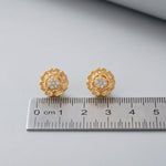 18k Gold plated earrings with diamond accents on a gray surface next to a ruler for scale.