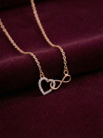 18k gold plated Necklace with heart and infinity symbol pendant on a purple fabric background